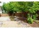 Fenced backyard featuring a river rock bed, mature trees, and a concrete patio at 20630 E Hamilton Ave, Aurora, CO 80013