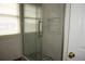 Bright bathroom features a glass shower door, and tiled floors at 20630 E Hamilton Ave, Aurora, CO 80013