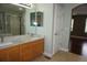 Bright bathroom featuring double vanity sinks with stone countertops, bathtub, and a closet at 20630 E Hamilton Ave, Aurora, CO 80013