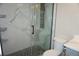 Modern bathroom features marble walls, a hexagon tile floor, a glass shower, and updated fixtures at 20630 E Hamilton Ave, Aurora, CO 80013