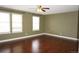 Spacious bedroom features hardwood floors, neutral paint, and ample natural light from multiple windows at 20630 E Hamilton Ave, Aurora, CO 80013