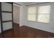 The bright bedroom features a sliding door, hardwood floors and ample natural light from windows at 20630 E Hamilton Ave, Aurora, CO 80013