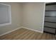 Bedroom with wood floors, a window, and a closet with brown sliding doors at 20630 E Hamilton Ave, Aurora, CO 80013