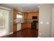 Well-lit kitchen featuring wooden cabinetry, ample counter space, and sliding glass doors to the backyard at 20630 E Hamilton Ave, Aurora, CO 80013