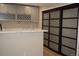 Modern kitchen features sleek countertops, stylish gray cabinets, a wine rack, and frosted sliding door at 20630 E Hamilton Ave, Aurora, CO 80013