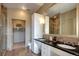 Luxurious bathroom with double sinks, granite countertops, walk-in shower, and separate water closet at 5455 Landmark Pl # 1403, Greenwood Village, CO 80111