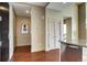 Hallway with hardwood floors and entry to kitchen area at 5455 Landmark Pl # 1403, Greenwood Village, CO 80111