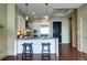 Modern kitchen with white cabinets, stainless steel appliances, and pendant lighting above breakfast bar with seating at 5455 Landmark Pl # 1403, Greenwood Village, CO 80111