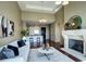 Open-concept living room with a cozy fireplace and a view of the modern kitchen area at 5455 Landmark Pl # 1403, Greenwood Village, CO 80111