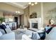 Open concept living room with fireplace, hardwood floors, and kitchen access at 5455 Landmark Pl # 1403, Greenwood Village, CO 80111