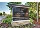 Elegant community sign for 'The Landmark West' with lush landscaping at 5455 Landmark Pl # 1403, Greenwood Village, CO 80111