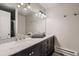 Bathroom featuring a double sink vanity, a large mirror and modern lighting fixtures at 7021 S Eudora St, Centennial, CO 80122