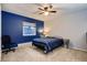 Bedroom with carpet flooring, dark blue accent wall, ceiling fan, and a window at 7021 S Eudora St, Centennial, CO 80122