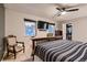 Bedroom with hardwood frame bed, carpet flooring, ceiling fan, and two windows at 7021 S Eudora St, Centennial, CO 80122