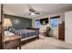 Bedroom with hardwood frame bed, carpet flooring, ceiling fan, and two windows at 7021 S Eudora St, Centennial, CO 80122