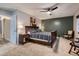 Bedroom with hardwood frame bed, carpet flooring, ceiling fan, and two windows at 7021 S Eudora St, Centennial, CO 80122