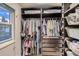 Customized closet with built-in storage solutions, hanging rods, shelves, drawers, and a window at 7021 S Eudora St, Centennial, CO 80122