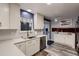 Modern kitchen with white cabinets, quartz countertops, stainless steel appliances, and stylish backsplash at 7021 S Eudora St, Centennial, CO 80122