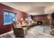 Cozy living room showcasing a brick fireplace, plush seating, and plenty of natural light at 7021 S Eudora St, Centennial, CO 80122