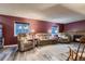 Comfortable living room with recliner seating, hardwood floors, and a brick fireplace at 7021 S Eudora St, Centennial, CO 80122