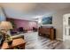 Spacious living room with modern flooring, stylish furniture, and a lovely open connection to the dining area at 7021 S Eudora St, Centennial, CO 80122