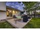 Back patio with a gas grill, table with 4 chairs, and an umbrella at 7021 S Eudora St, Centennial, CO 80122