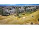 An aerial view showcasing the community's lush green golf course and surrounding residential area at 8403 Chase Dr, Arvada, CO 80003