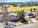 Beautiful aerial view of a home backing onto a golf course with mountain views at 8403 Chase Dr, Arvada, CO 80003
