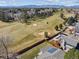 Expansive aerial view showcasing golf course, mountain views, and mature landscaping at 8403 Chase Dr, Arvada, CO 80003