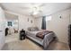 Carpeted bedroom with modern ceiling fan, natural light, and minimalist decor at 8403 Chase Dr, Arvada, CO 80003
