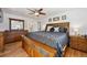 Bedroom with a ceiling fan, wooden furnishings, and neutral color scheme at 8403 Chase Dr, Arvada, CO 80003