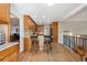 Open-concept kitchen featuring wood cabinets, granite countertops, hardwood floors, and barstool seating at 8403 Chase Dr, Arvada, CO 80003