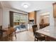 Bright kitchen featuring wood cabinets, granite countertops, hardwood floors, and sliding glass doors to outdoor patio at 8403 Chase Dr, Arvada, CO 80003
