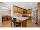 Eat-in kitchen with granite countertops, wooden cabinets, stainless steel appliances, and hardwood floors at 8403 Chase Dr, Arvada, CO 80003