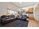 Bright living room with hardwood floors, comfortable leather sofas, and a staircase leading up at 8403 Chase Dr, Arvada, CO 80003