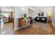 The living room features hardwood floors, a comfortable black leather sofa, and a decorative cabinet at 8403 Chase Dr, Arvada, CO 80003