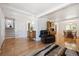 Bright living room with hardwood floors, wooden staircase and a view into the dining room at 8403 Chase Dr, Arvada, CO 80003