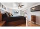 Spacious bedroom boasts hardwood floors, ceiling fan, and sliding door access to outdoor living at 8403 Chase Dr, Arvada, CO 80003