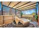 The outdoor seating area has a shade awning, privacy lattice and cozy furniture at 8403 Chase Dr, Arvada, CO 80003