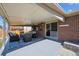 Cozy covered patio with outdoor seating area perfect for relaxing or entertaining guests at 8403 Chase Dr, Arvada, CO 80003