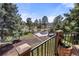 Balcony overlooking landscaped yard with mature trees and blue sky in background at 7570 Windford, Parker, CO 80134