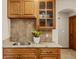 Bar area features granite countertop, stainless steel sink, wood cabinets and drawers at 7570 Windford, Parker, CO 80134
