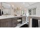 Luxurious bathroom with dual vanities, elegant mirrors, and modern finishes at 7570 Windford, Parker, CO 80134