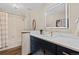 Bathroom features white countertop, modern sink, vanity with gold pulls and framed mirror with light at 7570 Windford, Parker, CO 80134