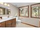 Bathroom vanity with modern sink, two windows and tile flooring at 7570 Windford, Parker, CO 80134