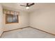 Simple bedroom with neutral colors, a ceiling fan, and natural light at 7570 Windford, Parker, CO 80134