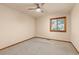 Bedroom with tan walls and carpet features ceiling fan, and window with blinds providing ample natural light at 7570 Windford, Parker, CO 80134