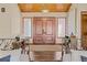 Elegant foyer with double doors, wood ceiling, and decorative metal railing at 7570 Windford, Parker, CO 80134