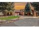 Charming home featuring stone accents, mature trees, a well-manicured lawn, and a spacious driveway at 7570 Windford, Parker, CO 80134