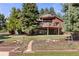 Stunning two-story home with a charming gazebo-covered deck, surrounded by mature trees and beautiful landscaping at 7570 Windford, Parker, CO 80134